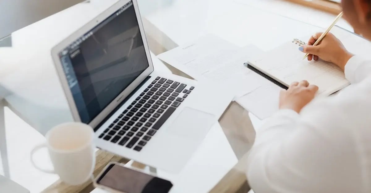 Person reviewing amazon section 3 violation appeal on laptop at desk with coffee and notes.