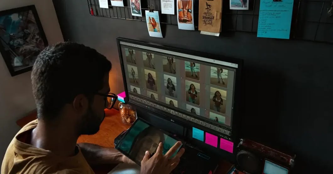 Designer editing product photos on monitor with grid layout, following amazon image requirements standards.